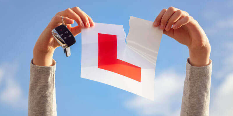 Hands in the air ripping l-plate in half