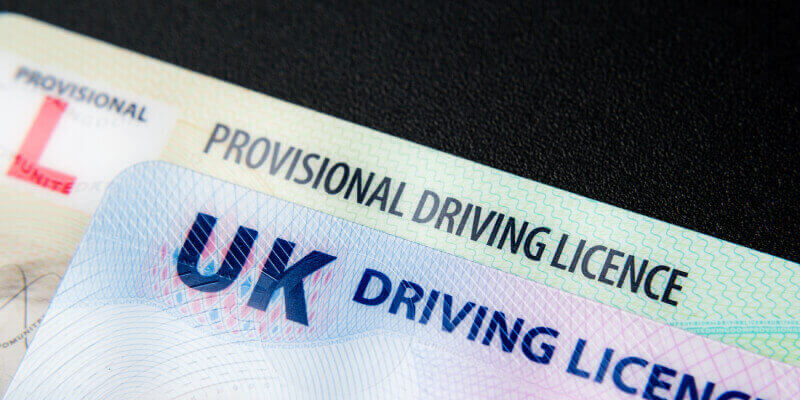 UK provisional licence and driving licence stacked