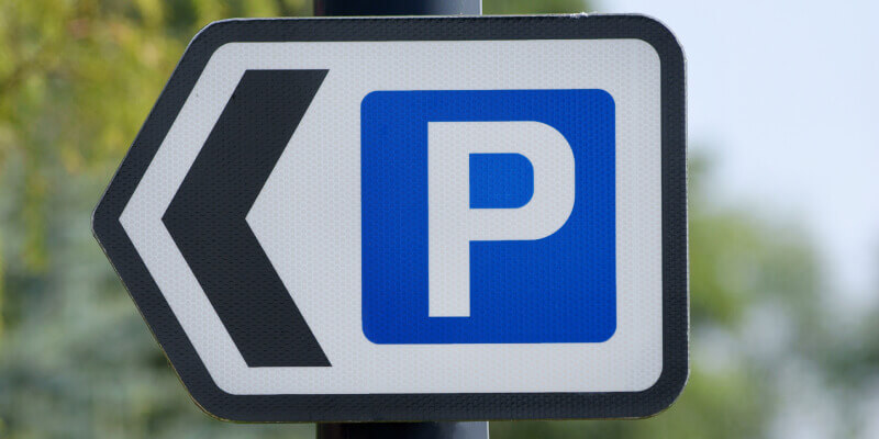 Parking sign attached to post