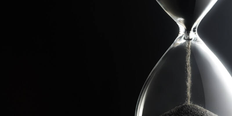 Image of a glass timer with sand running through
